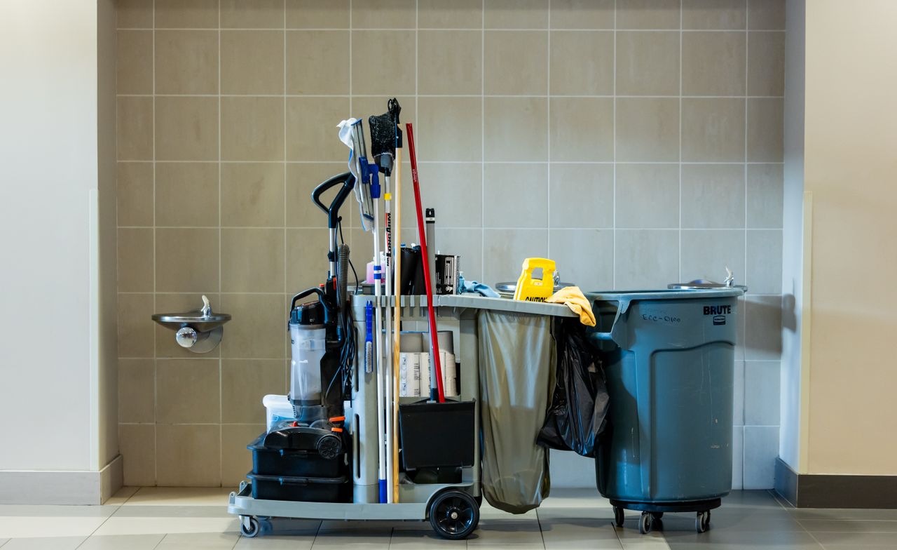 hero-img-01 A comprehensive collection of professional cleaning tools on a cart in an indoor environment.